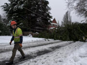 Parker McFadden of Asplundh lens a hand after a tree toppled power lines, knocked out power and closed Northeast 114th Avenue in both directions to traffic following an ice storm Monday morning, Feb. 15, 2021.