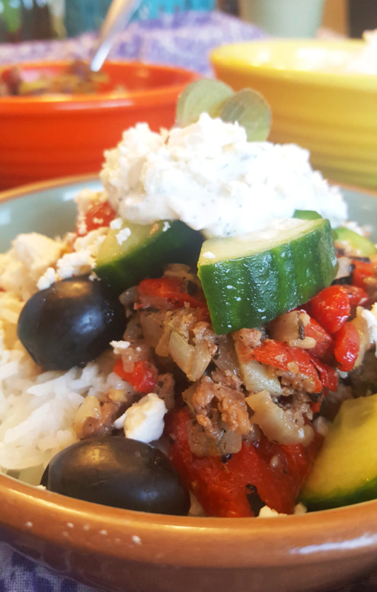 Haystacks are a completely customizable meal that can be changed to fit any taste or budget. These Greek Haystacks are made with rice, lamb, tomatoes and cucumbers, black olives, feta and tzatziki.