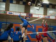 Ridgefield&#039;s Ali Andrew rises up for a hit on Tuesday at Ridgefield High School. Ridgefield won 25-20, 25-9, 25-12 over Mark Morris in its first volleyball match since winning the 2A State Championship in fall 2019.