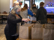 CDM Caregiving Services employee Ginger Barnwell picks up six meals for seniors in need at Pizzeria La Sorrentina in Vancouver.