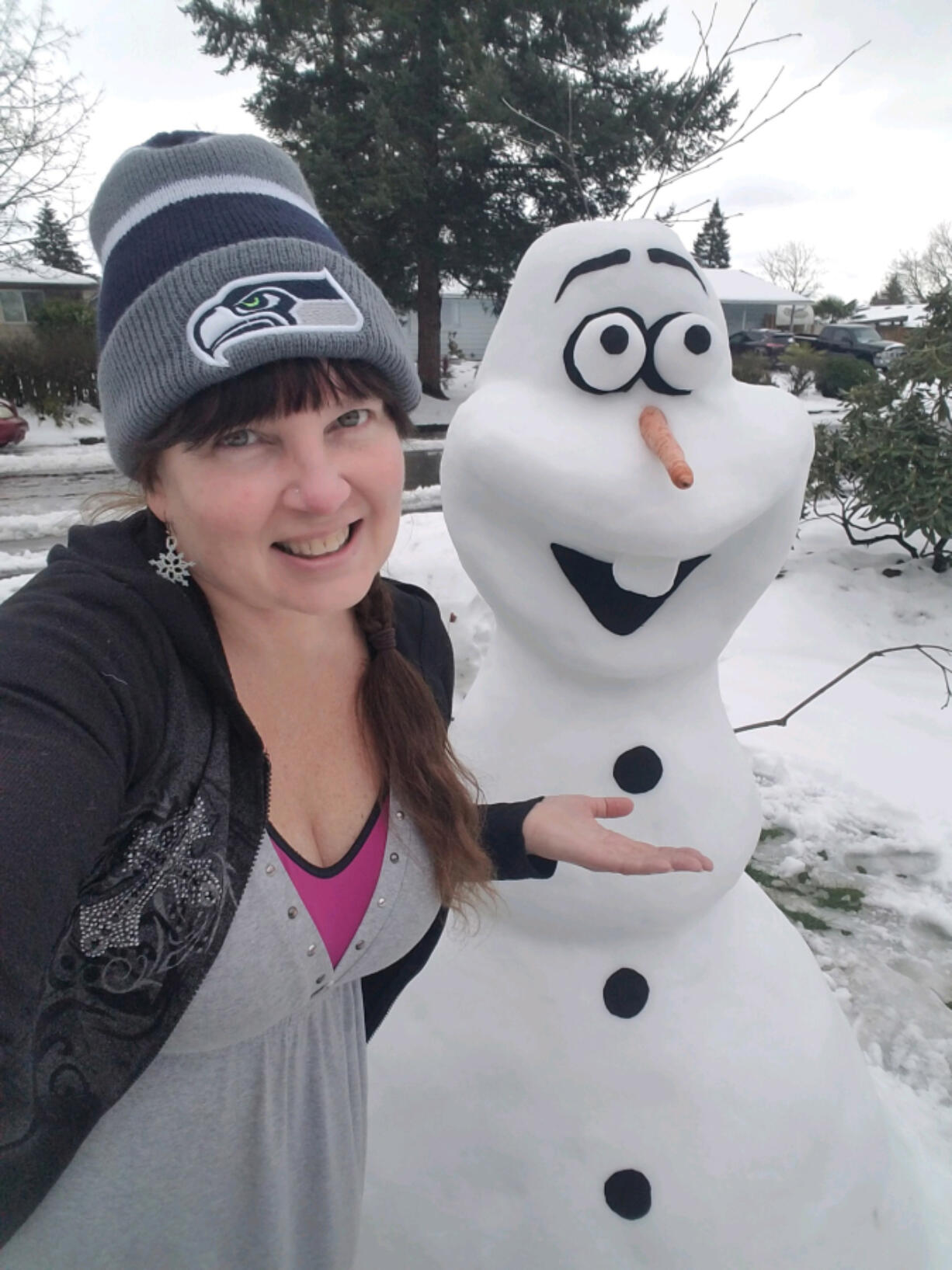 ORCHARDS: Laura Mathews constructed popular &quot;Frozen&quot; movie character Olaf in the yard of her Orchards home after a snow storm hit the region earlier this month.