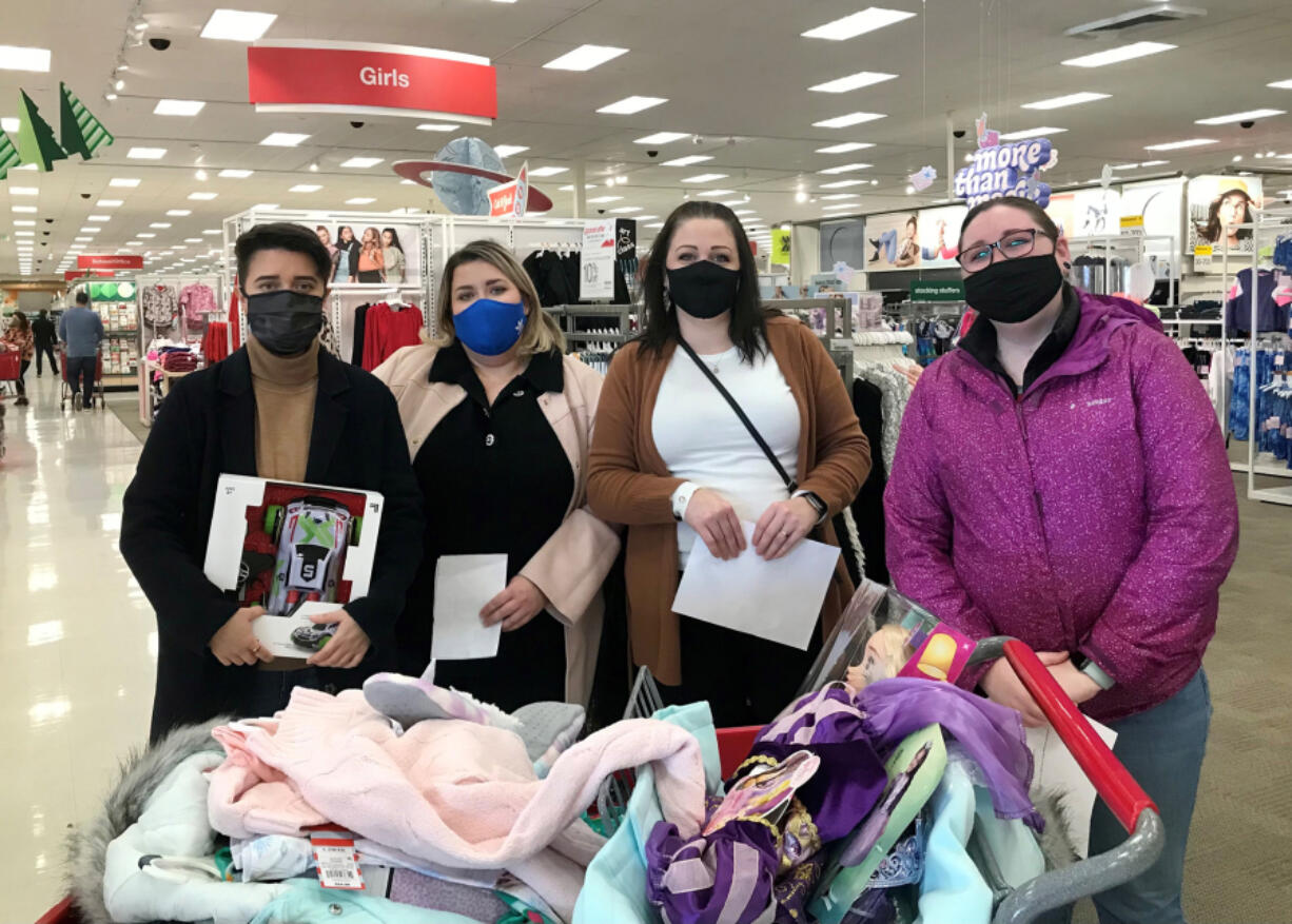 VAN MALL: TMG employees Michelle Villarma, Megan Francis, Elizabeth Divers and Vanessa MacAllister shopped for holiday gifts for foster children sponsored by TMG Cares.