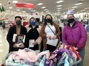 VAN MALL: TMG employees Michelle Villarma, Megan Francis, Elizabeth Divers and Vanessa MacAllister shopped for holiday gifts for foster children sponsored by TMG Cares.