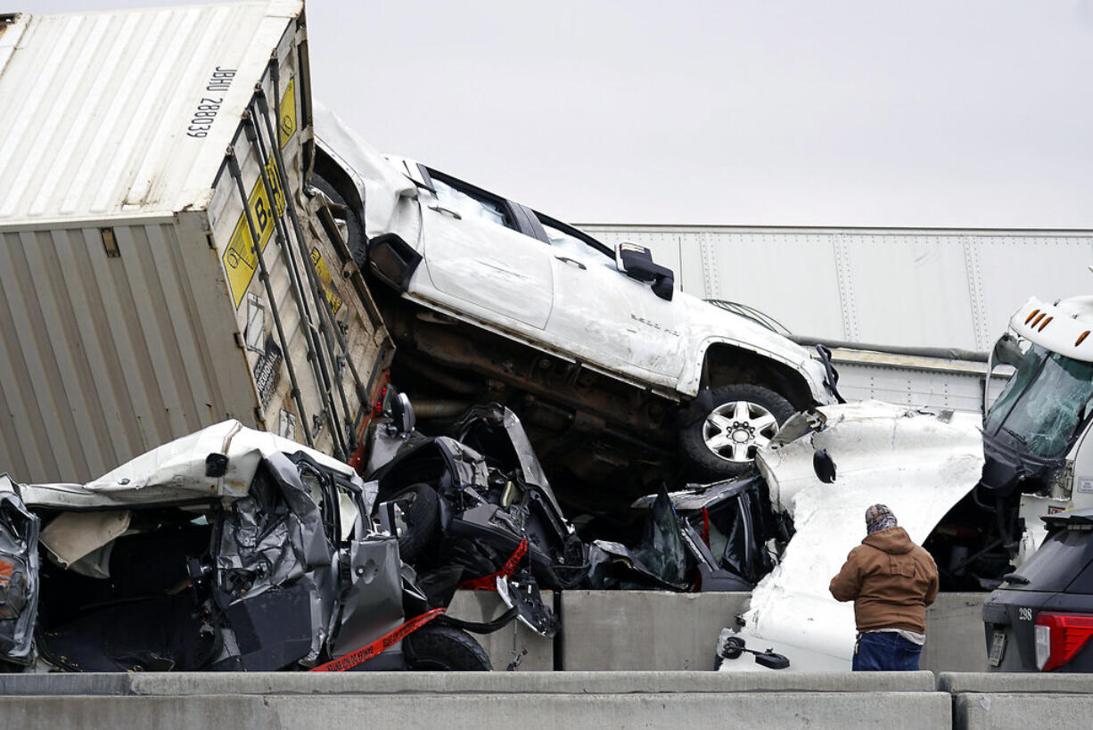 Vehicles are piled up after a fatal crash on Interstate 35 near Fort Worth, Texas on Thursday, Feb. 11, 2021.  The massive crash involving 75 to 100 vehicles on an icy Texas interstate killed some and injured others, police said, as a winter storm dropped freezing rain, sleet and snow on parts of the U.S.