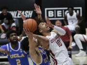 Washington State guard Isaac Bonton, right, shoots while pressured by UCLA guard Jules Bernard during the second half of an NCAA college basketball game in Pullman, Wash., Thursday, Feb. 11, 2021. Washington State won 81-73.