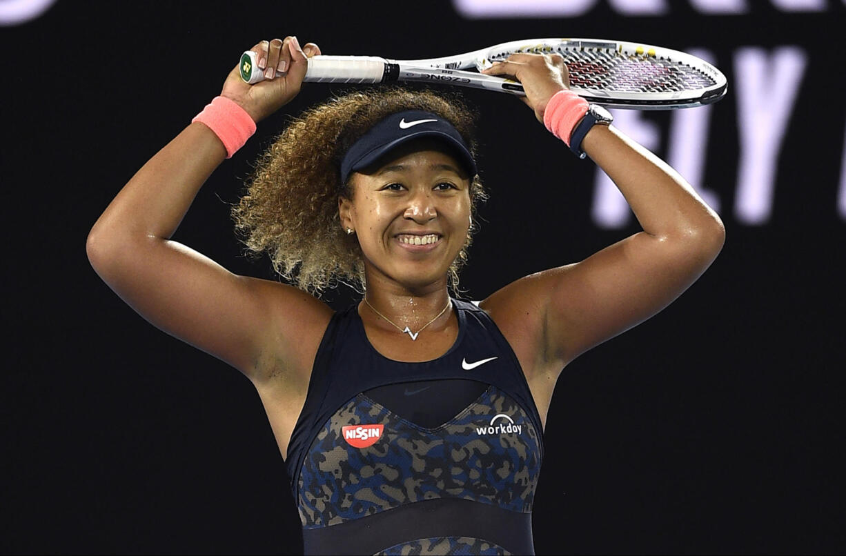 Japan's Naomi Osaka celebrates after defeating United States' Jennifer Brady during the women's singles final at the Australian Open tennis championship in Melbourne, Australia, Saturday, Feb.