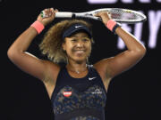 Japan's Naomi Osaka celebrates after defeating United States' Jennifer Brady during the women's singles final at the Australian Open tennis championship in Melbourne, Australia, Saturday, Feb.