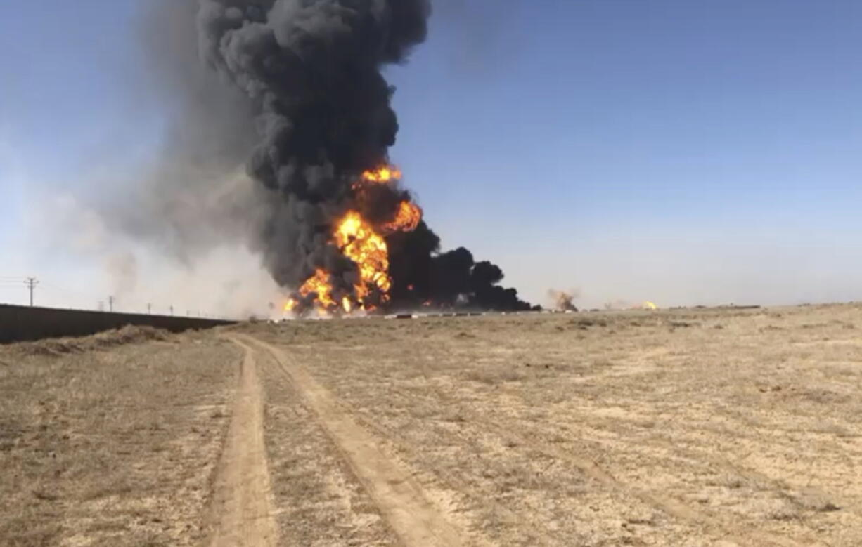 Smoke rises from fuel tankers at the Islam Qala border with Iran, in Herat Province, west  of Kabul, Afghanistan, Saturday.