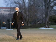 President Joe Biden walks on the South Lawn of the White House after stepping off Marine One, Friday, Feb. 19, 2021, in Washington. Biden is returning to Washington after visiting Pfizer&#039;s COVID-19 vaccine manufacturing site near Kalamazoo, Mich.