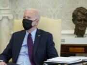 President Joe Biden speaks with House Democratic Leaders in the Oval Office of the White House, Friday, Feb. 5, 2021, in Washington.