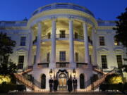 From left, President Joe Biden, first lady Jill Biden, Vice President Kamala Harris and her husband, Doug Emhoff, stand outside the White House during a ceremony Monday to honor the 500,000 Americans who died from COVID-19.