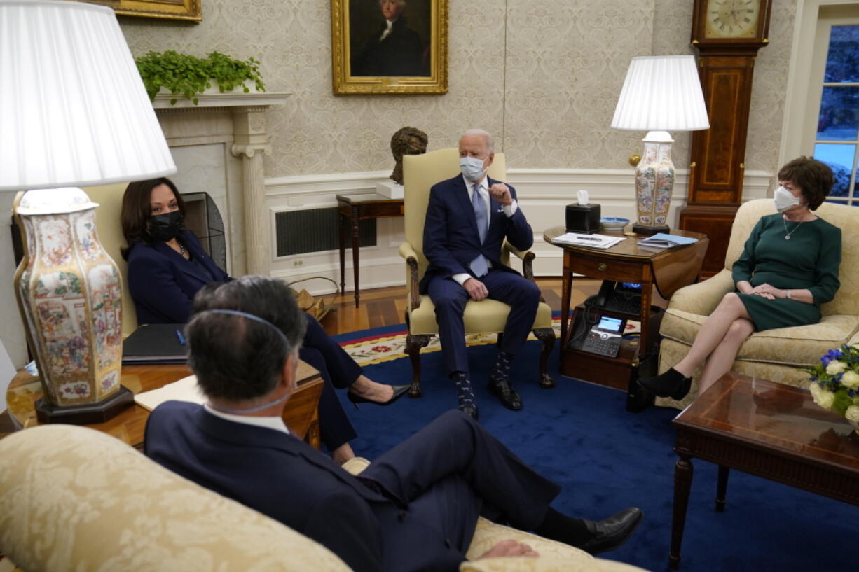 President Joe Biden meets with Sen. Susan Collins, R-Maine, right, Sen. Mitt Romney, R-Utah, and others to discuss a coronavirus relief package, in the Oval Office of the White House, Monday, Feb. 1, 2021, in Washington.