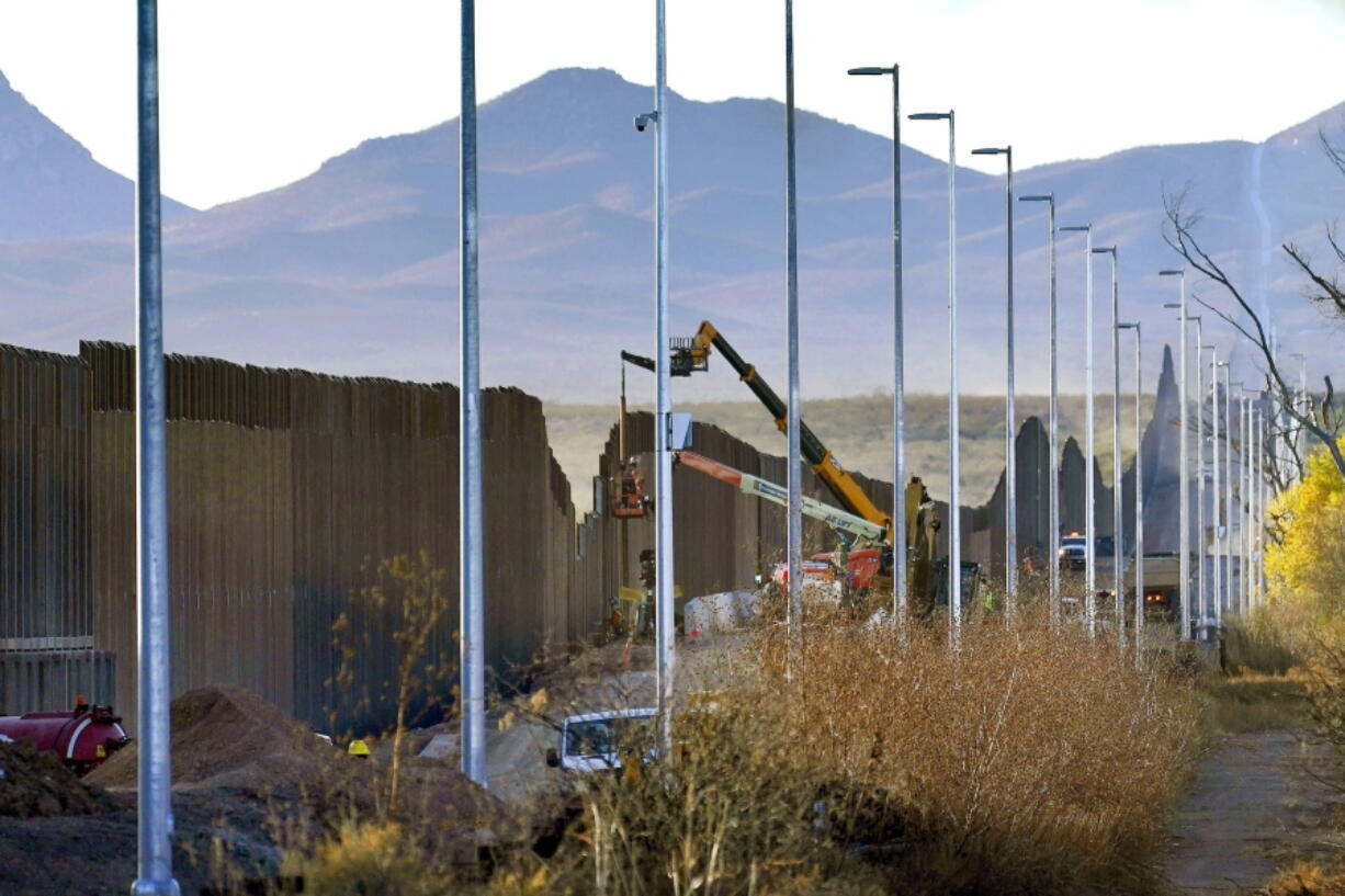 Crews work on the construction of a section of border wall Dec. 8 in the San Bernardino National Wildlife Refuge in Douglas, Ariz.