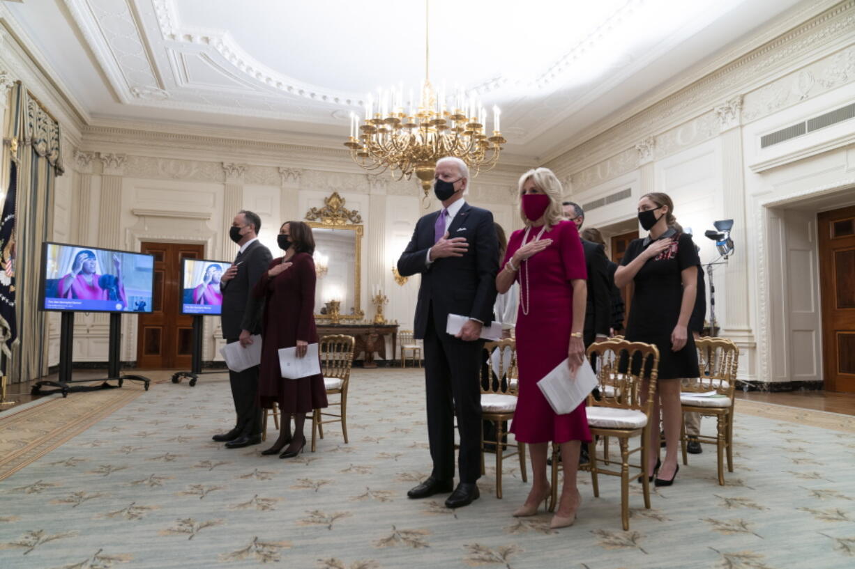 FILE - In this Jan. 21, 2021, file photo, Doug Emhoff, left, Vice President Kamala Harris, President Joe Biden, and first lady Jill Biden, stand during a performance of the National Anthem during a virtual Presidential Inaugural Prayer Service, in the State Dinning Room of the White House in Washington. Biden is expected to address the National Prayer Breakfast, a Washington tradition that calls on political combatants to set aside their differences for one morning.