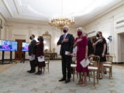 FILE - In this Jan. 21, 2021, file photo, Doug Emhoff, left, Vice President Kamala Harris, President Joe Biden, and first lady Jill Biden, stand during a performance of the National Anthem during a virtual Presidential Inaugural Prayer Service, in the State Dinning Room of the White House in Washington. Biden is expected to address the National Prayer Breakfast, a Washington tradition that calls on political combatants to set aside their differences for one morning.