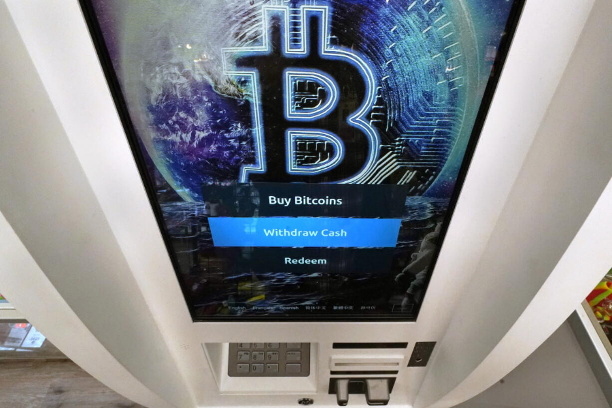 The Bitcoin logo appears on the display screen of a crypto currency ATM at the Smoker&#039;s Choice store, Tuesday, Feb. 9, 2021, in Salem, N.H.  After a wild week in which Bitcoin soared to new heights, Bitcoin is crossing the $50,000 mark. Bitcoin rallied last week as more companies signaled the volatile digital currency could eventually gain widespread acceptance as a means of payment for goods and services.