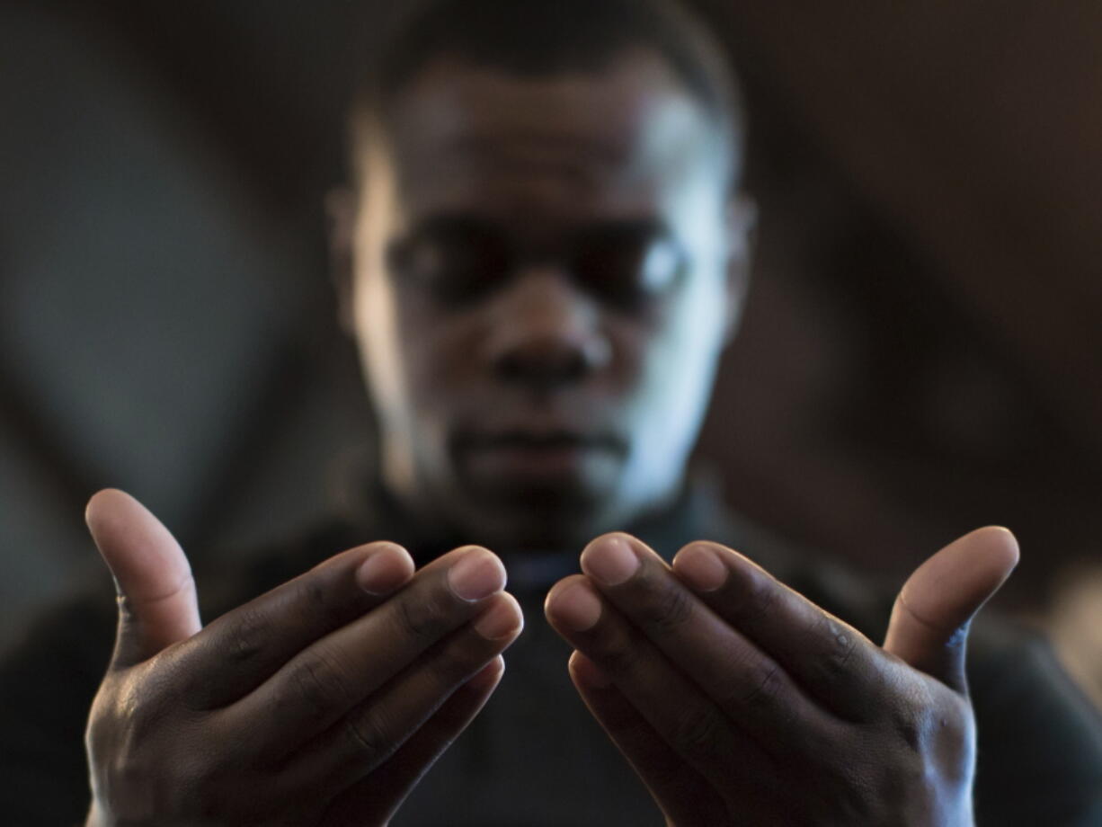 FILE - In this Monday, July 11, 2016 file photo, Paul Bronson prays during a Black Lives Matter prayer vigil at First Baptist Church, a predominantly African-American congregation, in Macon, Ga. According to a Pew study released on Tuesday, Feb. 16, 2021, Black Americans attend church more regularly than Americans overall, and pray more often. Most of them attend churches that are predominantly Black -- yet many would like those congregations to become racially diverse.