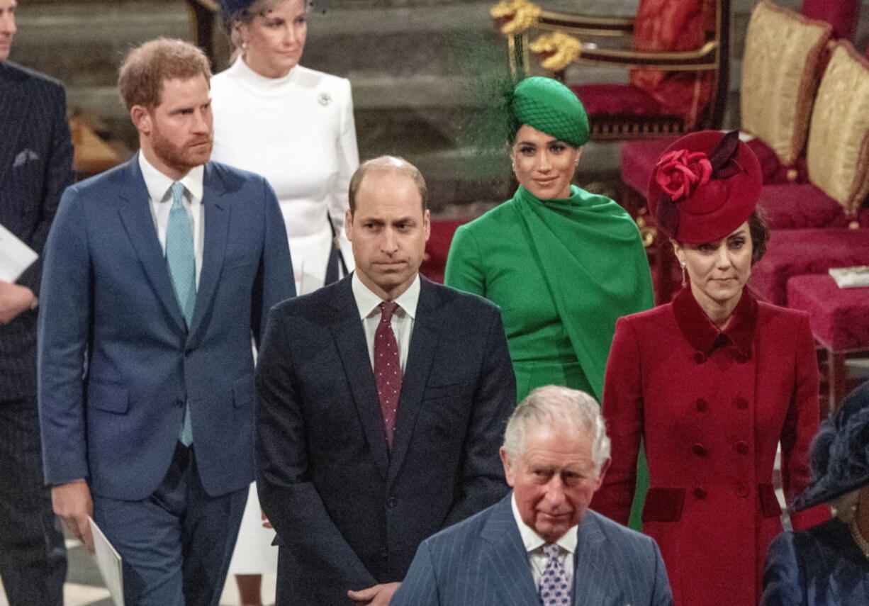 FILE - In this file photo dated Monday March 9, 2020, from back, Britain&#039;s Prince Harry and Meghan Duchess of Sussex, Prince William and Kate, Duchess of Cambridge, with Prince Charles, front, as the family members leave the annual Commonwealth Service at Westminster Abbey in London.  Harry and Meghan stepped away from full-time royal life early 2020, and Buckingham Palace on Friday Feb.