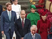 FILE - In this file photo dated Monday March 9, 2020, from back, Britain&#039;s Prince Harry and Meghan Duchess of Sussex, Prince William and Kate, Duchess of Cambridge, with Prince Charles, front, as the family members leave the annual Commonwealth Service at Westminster Abbey in London.  Harry and Meghan stepped away from full-time royal life early 2020, and Buckingham Palace on Friday Feb.