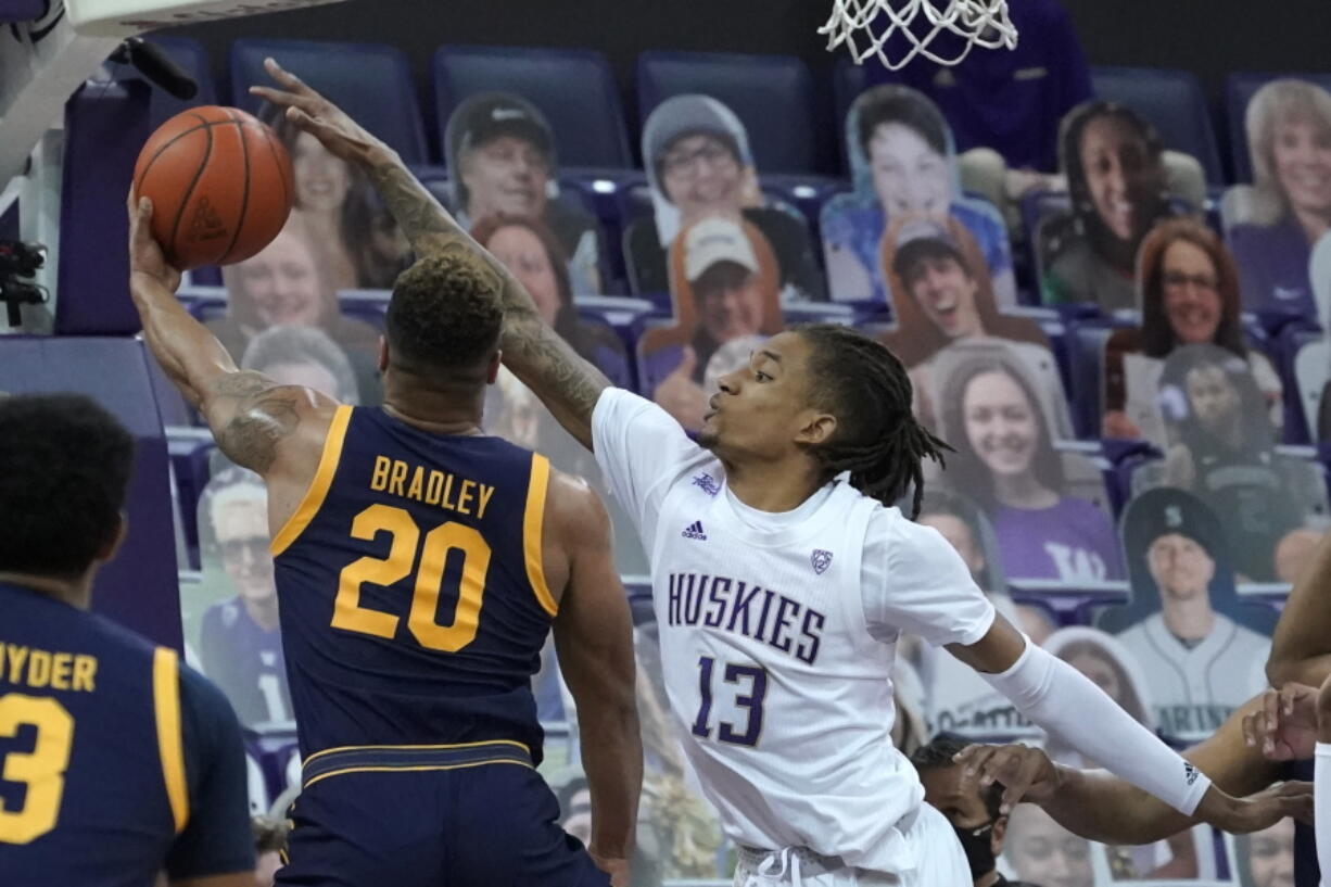 Washington forward Hameir Wright (13) blocks a shot by California guard Matt Bradley (20) during the first half of an NCAA college basketball game Saturday, Feb. 20, 2021, in Seattle. (AP Photo/Ted S.