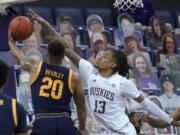 Washington forward Hameir Wright (13) blocks a shot by California guard Matt Bradley (20) during the first half of an NCAA college basketball game Saturday, Feb. 20, 2021, in Seattle. (AP Photo/Ted S.