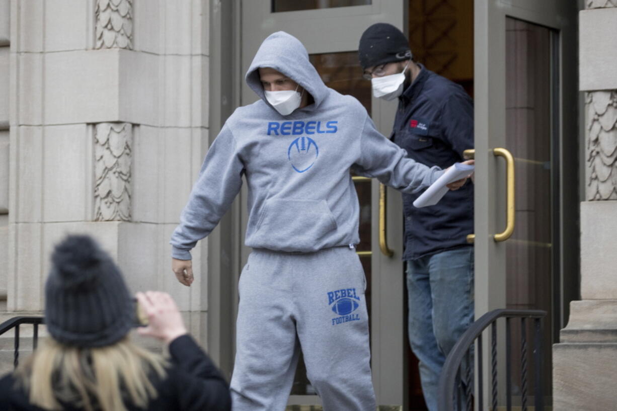 FILE - West Virginia Republican state Del. Derrick Evans exits the Sidney L. Christie U.S. Courthouse and Federal Building after being arraigned, Friday, Jan. 8, 2021, in Huntington, W.Va. Evans has resigned as he faces charges of entering a restricted area of the U.S. Capitol after he livestreamed himself with rioters. In a letter Saturday, Jan. 9,  Evans notified GOP Gov. Jim Justice of his resignation, effective immediately.