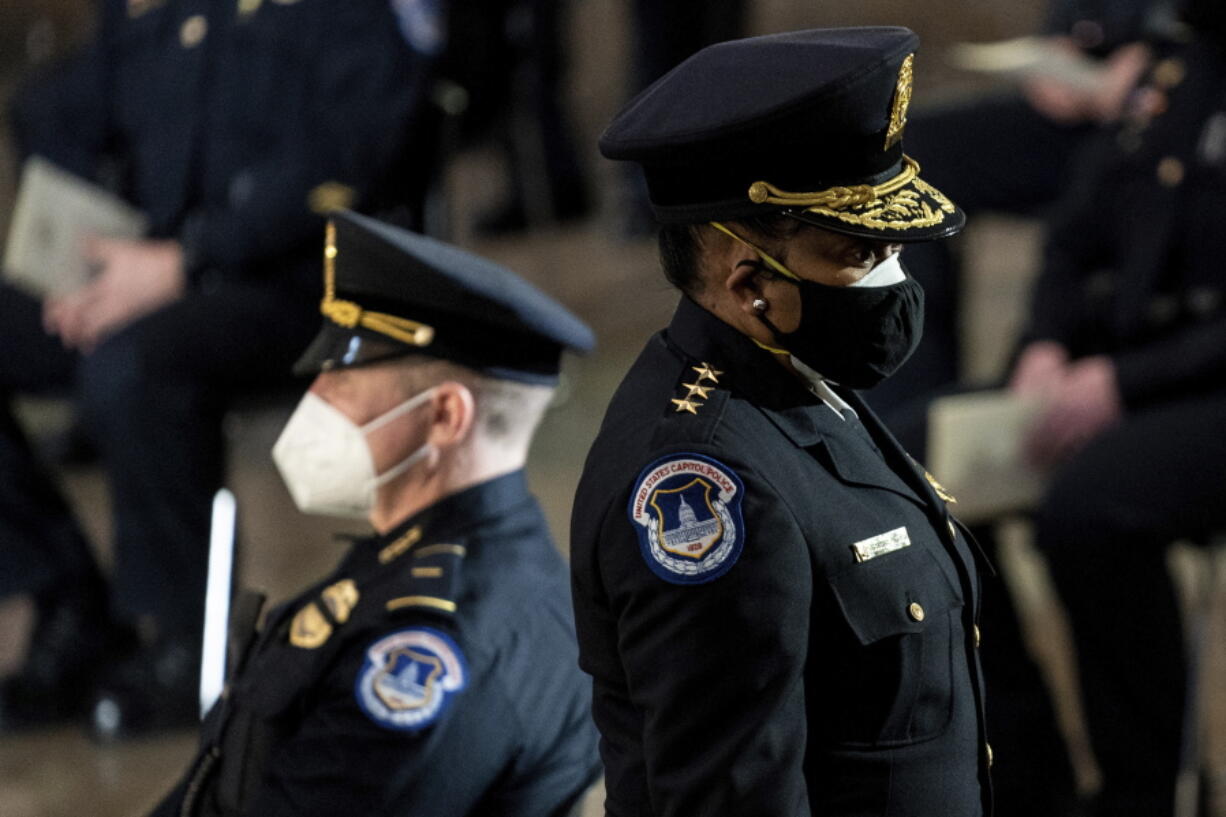 Capitol Police Acting Chief Yogananda Pittman departs a ceremony memorializing U.S. Capitol Police officer Brian Sicknick, as an urn with his cremated remains lies in honor on a black-draped table at the center of the Capitol Rotunda, Wednesday, Feb. 3, 2021, in Washington.