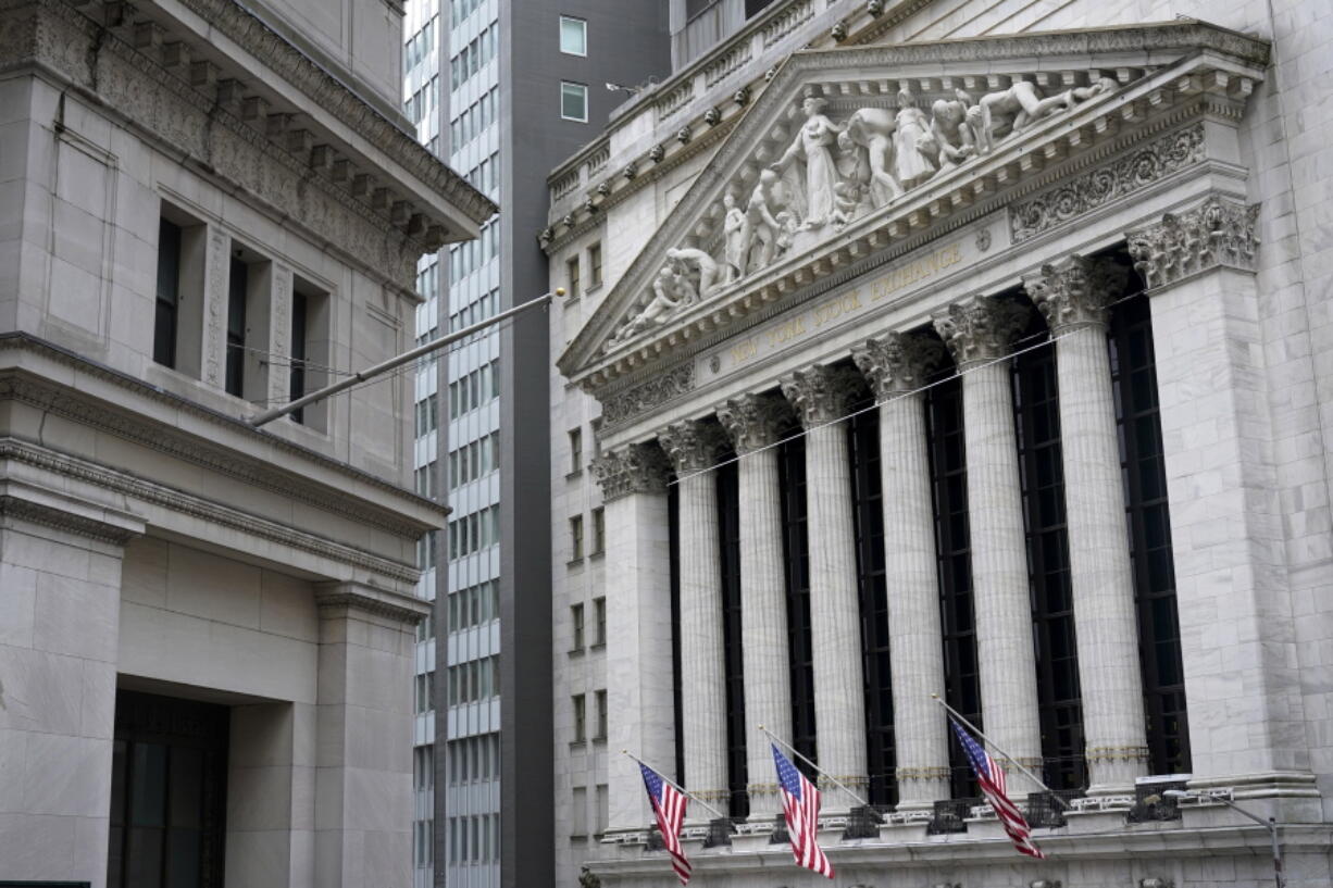 FILE - This Nov. 23, 2020 file photo shows the New York Stock Exchange, right, in New York.  Banks and energy companies are helping to lead stocks mostly lower in early trading on Wall Street, a day after major indexes set their latest record highs. The S&amp;P 500 fell 0.2% in the early going Tuesday, Feb. 9, 2021.