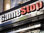 Pedestrians pass a GameStop store Thursday in the Manhattan borough of New York. GameStop stock had rocketed from below $20 to more than $400 this month as a volunteer army of investors on social media challenged big institutions who has placed market bets that the stock would fall.