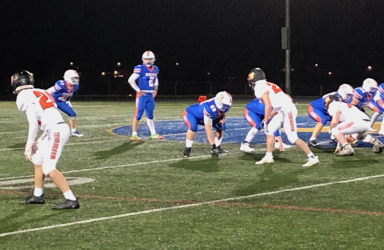 Ridgefield quarterback Luke Price (2) surveys the field before a play in Friday's 48-0 win over Washougal at Ridgefield High (Micah Rice/The Columbian)