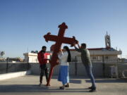 Iraqi Christians place a cross on a church in Qaraqosh, Iraq, on Feb. 22.