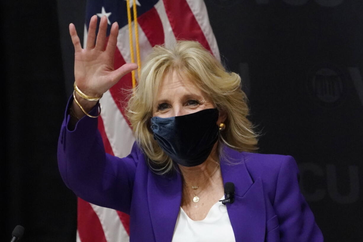 First lady Jill Biden waves to Virginia Gov. Ralph Northam, during a visit to the Massey Cancer center at Virginia Commonwealth University for a discussion about cancer disparities. in Richmond, Va., Wednesday, Feb. 24, 2021.