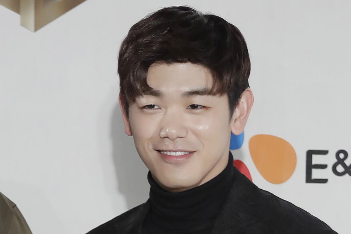 FILE - In this Dec. 2, 2016 file photo, South Korean-American singer-songwriter Eric Nam, poses for the photographers on the red carpet of the 2016 Mnet Asian Music Awards (MAMA) in Hong Kong. Korean American K-pop singers, including Nam, are sharing their experiences with stress in a series of podcasts addressing mental health issues to raise awareness beyond the K-pop community.