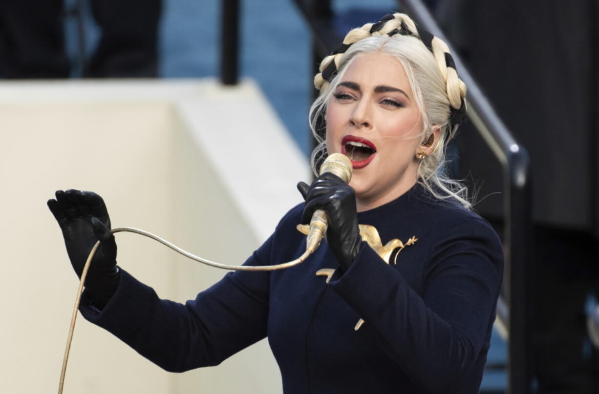 FILE - Lady Gaga sings the national anthem during President-elect Joe Biden&#039;s inauguration at the U.S. Capitol in Washington on Jan. 20, 2021. Officials say Lady Gaga&#039;s dog walker was shot and her two French bulldogs stolen in Hollywood during an armed robbery. Los Angeles police are seeking two suspects, thought it&#039;s not known if both were armed, in connection with the Wednesday night shooting.