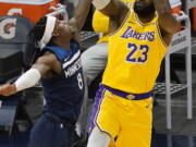 Los Angeles Lakers&#039; LeBron James (23) shoots as Minnesota Timberwolves&#039; Jarred Vanderbilt (8) defends in the first half of an NBA basketball game, Tuesday, Feb. 16, 2021, in Minneapolis.