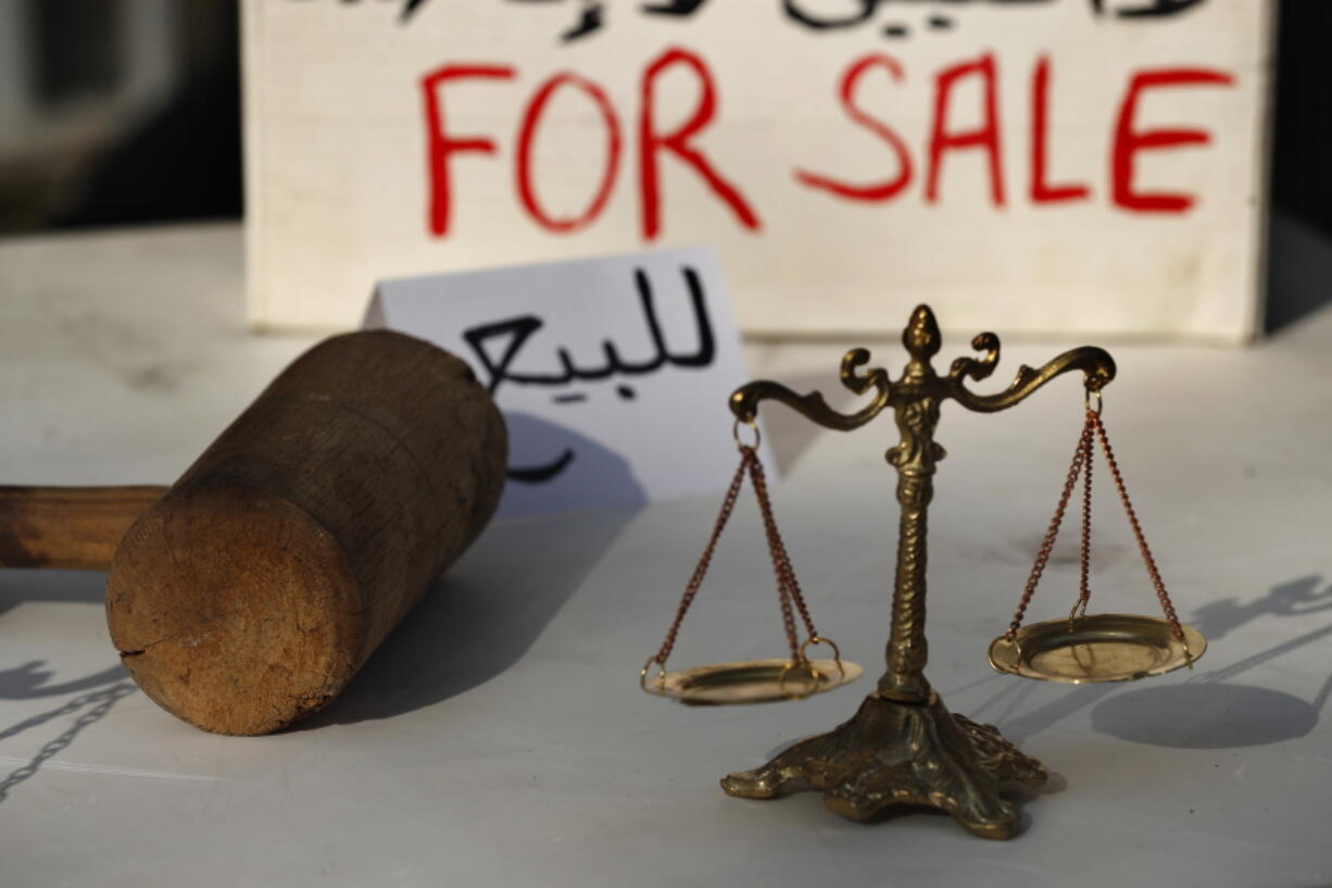 Lebanese activists display symbols of justice during a protest against the slow pace of the investigation into the August 4 explosion that hit Beirut&#039;s seaport, outside the Justice Palace, in Beirut, Lebanon, Dec. 3, 2020. The blast was one of the largest non-nuclear explosions in history and six months later, political and confessional rivalries have undermined the probe into the Beirut port explosion and brought it to a virtual halt, mirroring the same rivalries that have thwarted past attempts to investigate political crimes throughout Lebanon&#039;s history.