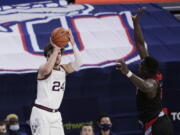 Gonzaga forward Corey Kispert shoots as Loyola Marymount guard Eli Scott defends during the second half of an NCAA college basketball game in Spokane, Wash., Saturday, Feb. 27, 2021.