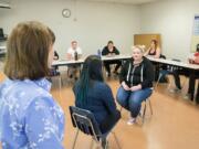 Clark College students enrolled in the Bachelor of Applied Science in Human Services program practice counseling techniques in the classroom while Professor Marcia Roi, bottom left, observes and provides guidance.