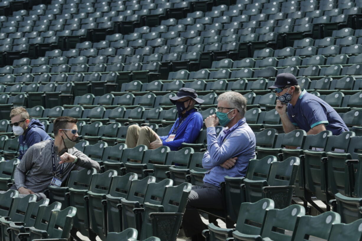 Seattle Mariners general manager Jerry Dipoto, second from left, manager Scott Servais, right, and team president and CEO Kevin Mather, second from right, watch a practice in July 2020. Dipoto and Servais are doing damage control with players who were directly mentioned or referenced by Mather in an online video that led to his resignation. (Ted S.