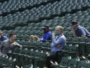 Seattle Mariners general manager Jerry Dipoto, second from left, manager Scott Servais, right, and team president and CEO Kevin Mather, second from right, watch a practice in July 2020. Dipoto and Servais are doing damage control with players who were directly mentioned or referenced by Mather in an online video that led to his resignation. (Ted S.