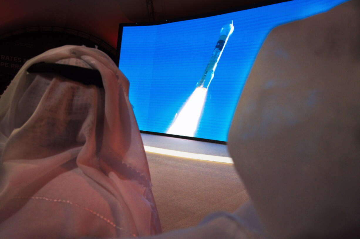 FILE - In this Monday, July 20, 2020 file photo, men watch the launch of the &quot;Amal&quot; or &quot;Hope&quot; space probe at the Mohammed bin Rashid Space Center in Dubai, United Arab Emirates. The orbiter is scheduled to reach Mars on Tuesday, Feb. 9, 2021, followed less than 24 hours later by China&#039;s orbiter-rover combo. NASA&#039;s rover will arrive on the scene a week later, on Feb. 18, to collect rocks for return to Earth -- a key step in determining whether life ever existed at Mars.