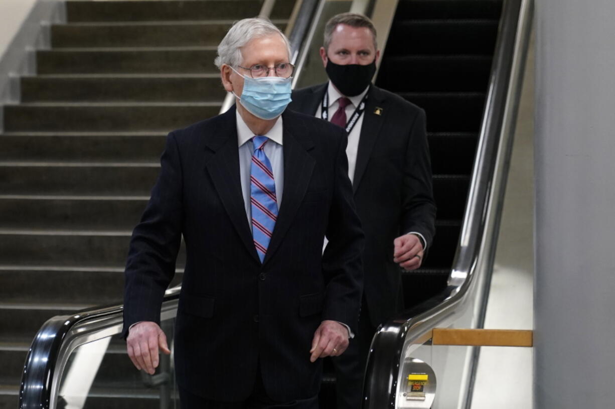 Senate Minority Leader Mitch McConnell of Ky., walks on Capitol Hill in Washington, Tuesday, Feb. 23, 2021.