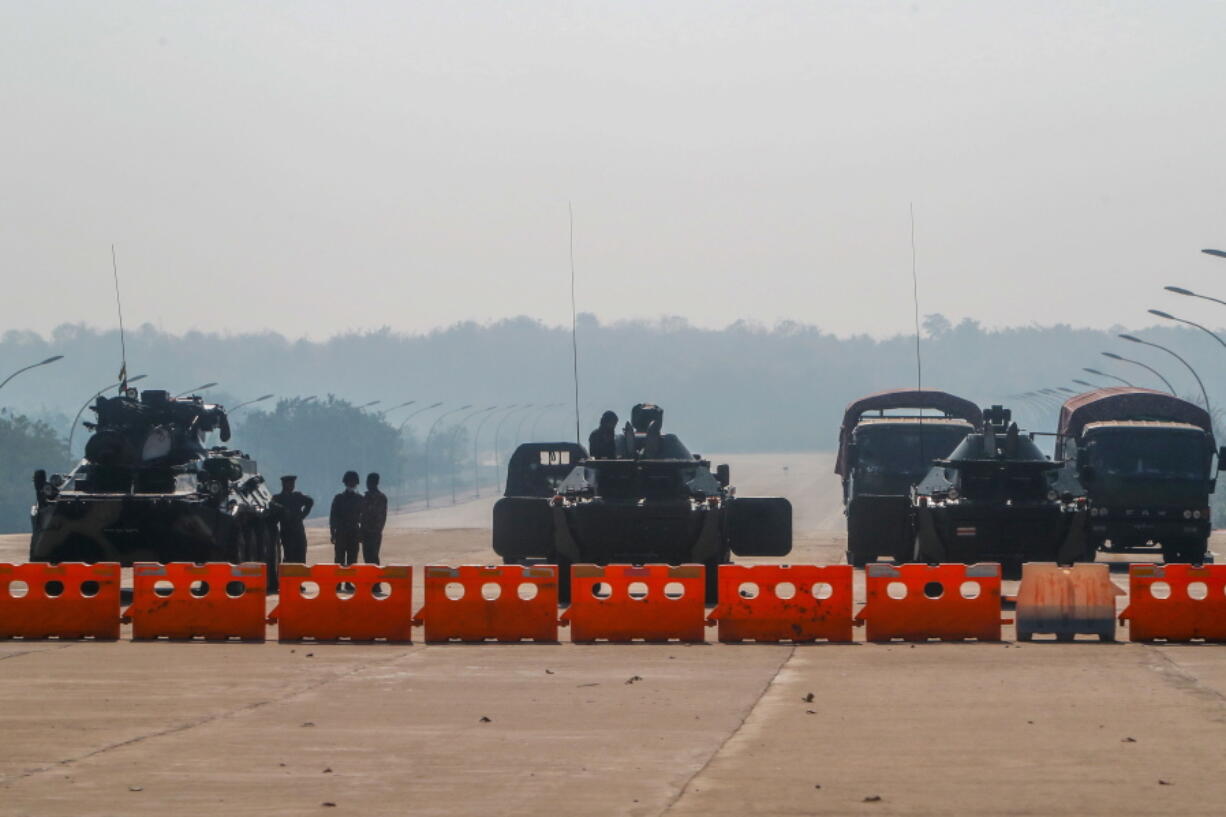 Myanmar&#039;s military stand guard at a checkpoint manned with an armored vehicles blocking a road leading to the parliament building Tuesday, Feb. 2, 2021, in Naypyitaw, Myanmar. Hundreds of members of Myanmar&#039;s Parliament remained confined inside their government housing in the country&#039;s capital on Tuesday, a day after the military staged a coup and detained senior politicians including Nobel laureate and de facto leader Aung San Suu Kyi.