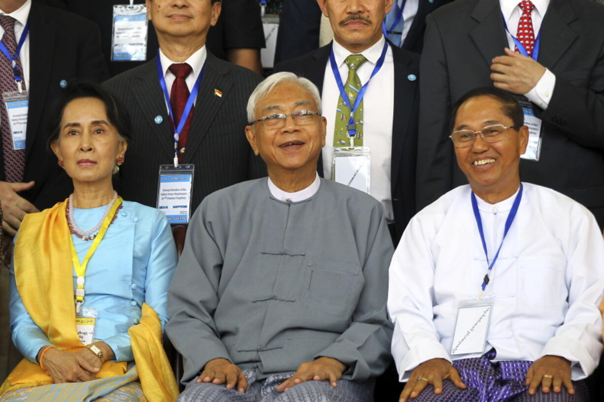 FILE - In this May 24, 2017, file photo, Myanmar&#039;s Vice President Myint Swe, right, smiles while sitting with State Counsellor Aung San Suu Kyi, left, and then President Htin Kyaw during a photo session after the second session of the 21st Century Panglong Union Peace Conference at the Myanmar International Convention Center in Naypyitaw, Myanmar. Myanmar military television said Monday, Feb. 1, 2021 that the military was taking control of the country for one year, while reports said many of the country&#039;s senior politicians including Suu Kyi had been detained. The military TV report said Commander-in-Chief Senior Gen. Min Aung Hlaing would be in charge of the country, while Myint Swe would be elevated to acting president.