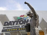 FILE - In this Feb. 16, 2011, file photo, a statue of Dale Earnhardt rises above an entrance at Daytona International Speedway in Daytona Beach, Fla. On the cusp of a national popularity explosion, NASCAR never stopped after the deaths of Adam Petty, Kenny Irwin Jr. and Tony Roper. But losing Earnhardt forced the stock car series to confront safety issues it had been slow to even acknowledge, let alone address. The dramatic upgrades have saved multiple lives -- NASCAR has not suffered a racing death in its three national series since -- and are the hallmark of Earnhardt&#039;s legacy.