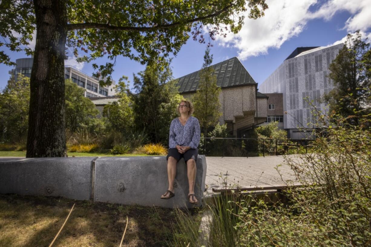 Ann Brower, the lone survivor from a bus which was hit by falling debris from a building during the Christchurch earthquake 10 years ago, sits at her workplace in Christchurch, New Zealand, Wednesday, Feb. 10, 2021. One woman has used her anger to ensure buildings are safer. Others have found peace after heartbreaking losses. Ten years after the earthquake in Christchurch killed 185 people and devastated the city, some of those profoundly affected are sharing their journeys.