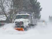 Two Walla Walla City snowplow clears a road of snow in Walla Walla, Wash., Friday, Feb.  12, 2021.  Snow fell throughout Western Washington and parts of Oregon.