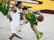 Oregon guard Chris Duarte (5) drives past Arizona State guard Remy Martin (1) during the first half of an NCAA college basketball basketball game, Thursday, Feb. 11, 2021, in Tempe, Ariz.