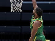 Oregon guard LJ Figueroa, top, dunks against California during the second half of an NCAA college basketball game in Berkeley, Calif., Saturday, Feb. 27, 2021.