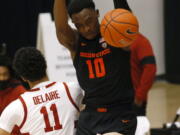 Oregon State forward Warith Alatishe (10) dunks in front of Stanford forward Jaiden Delaire (11) during the first half of an NCAA college basketball game in Stanford, Calif., Saturday, Feb. 27, 2021.